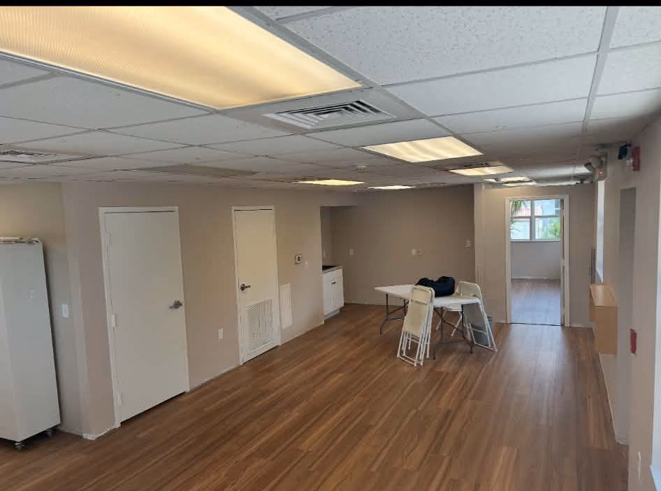 The finished Pine Manor main hall with new vinyl plank flooring and refinished walls
